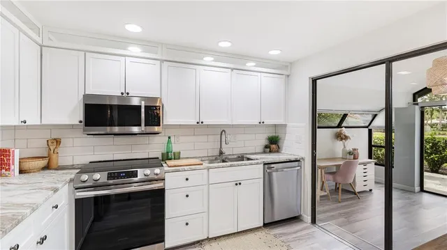 a kitchen with a sink stainless steel appliances and cabinets