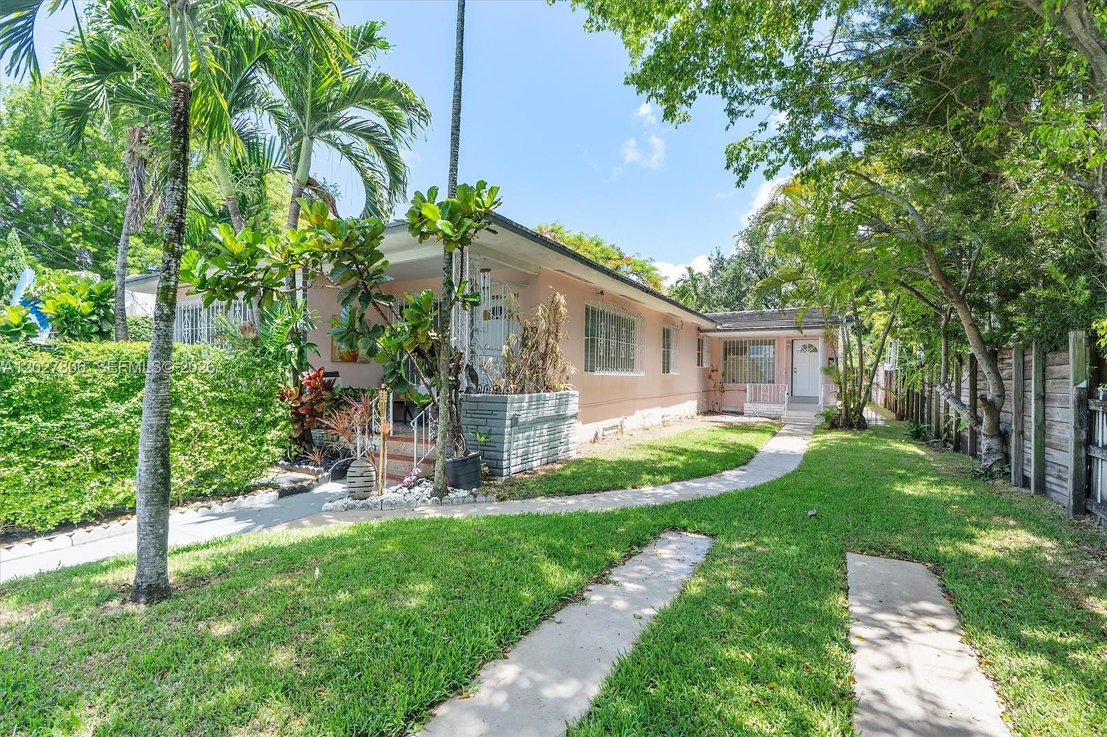 1612 Southwest 23rd Street, Unit 1612 Miami, FL 33145 - Photo 1 of 42 a front view of house with yard and green space