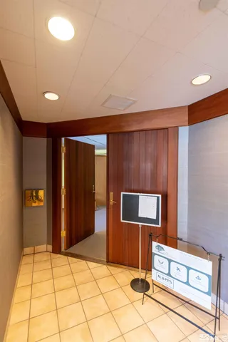 a living room with furniture and a gym machine