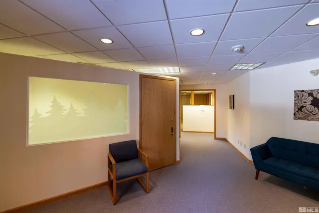 a spacious bedroom with a bed and a chandelier