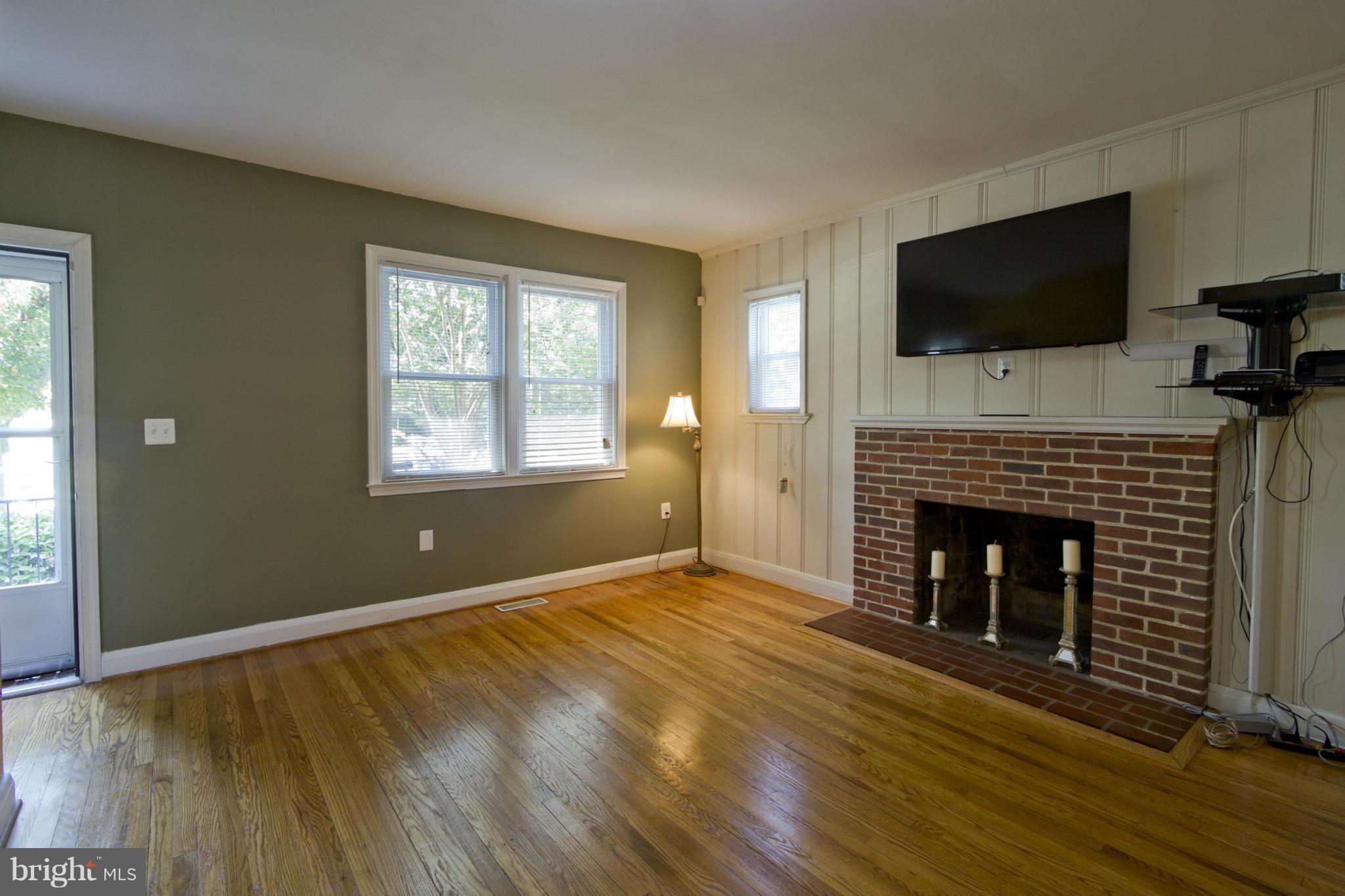 409 South Wickham Road Baltimore, MD 21229 - Photo 4 of 30 Living Room with Brick Fireplace