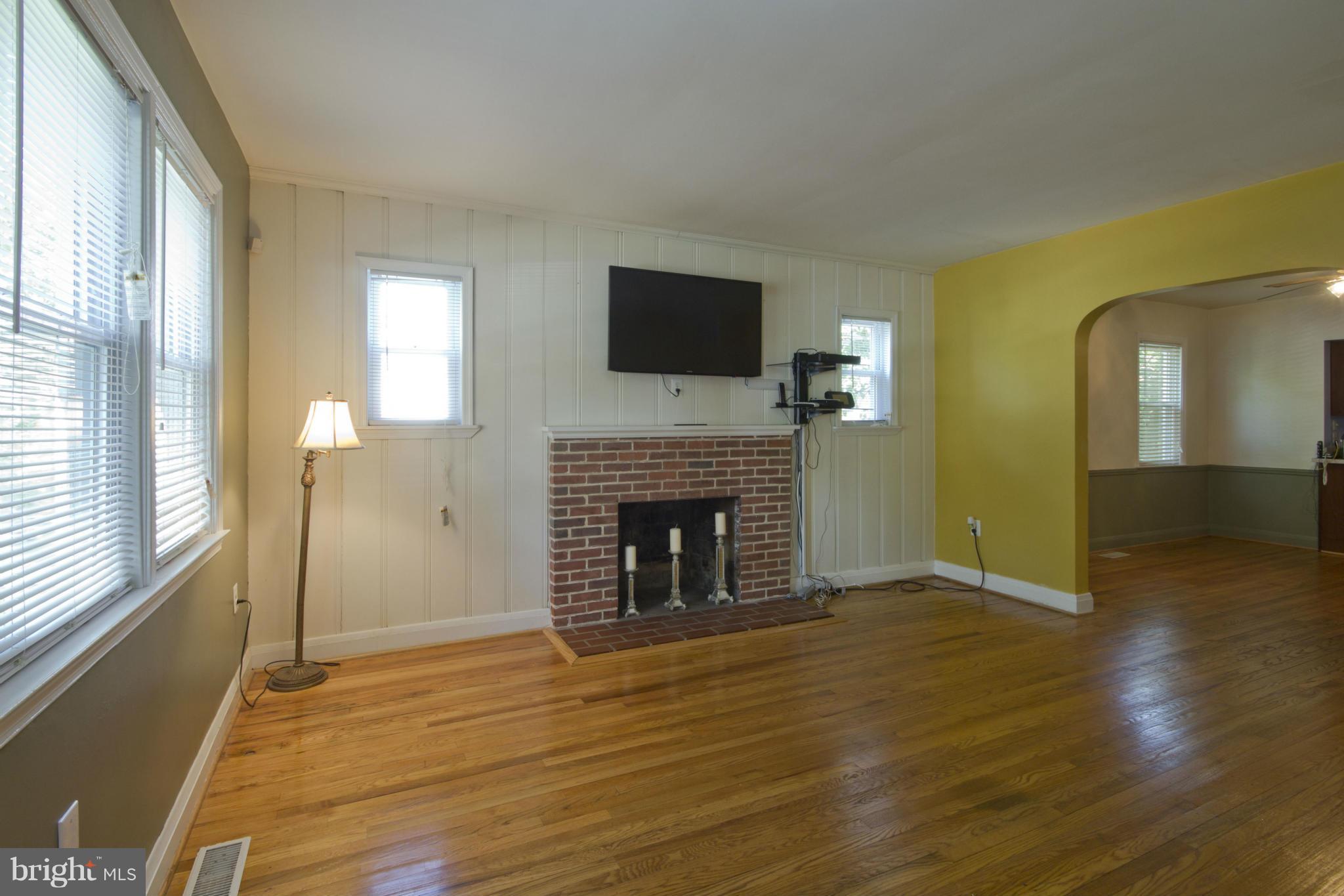 409 South Wickham Road Baltimore, MD 21229 - Photo 5 of 30 Living Room with Brick Fireplace