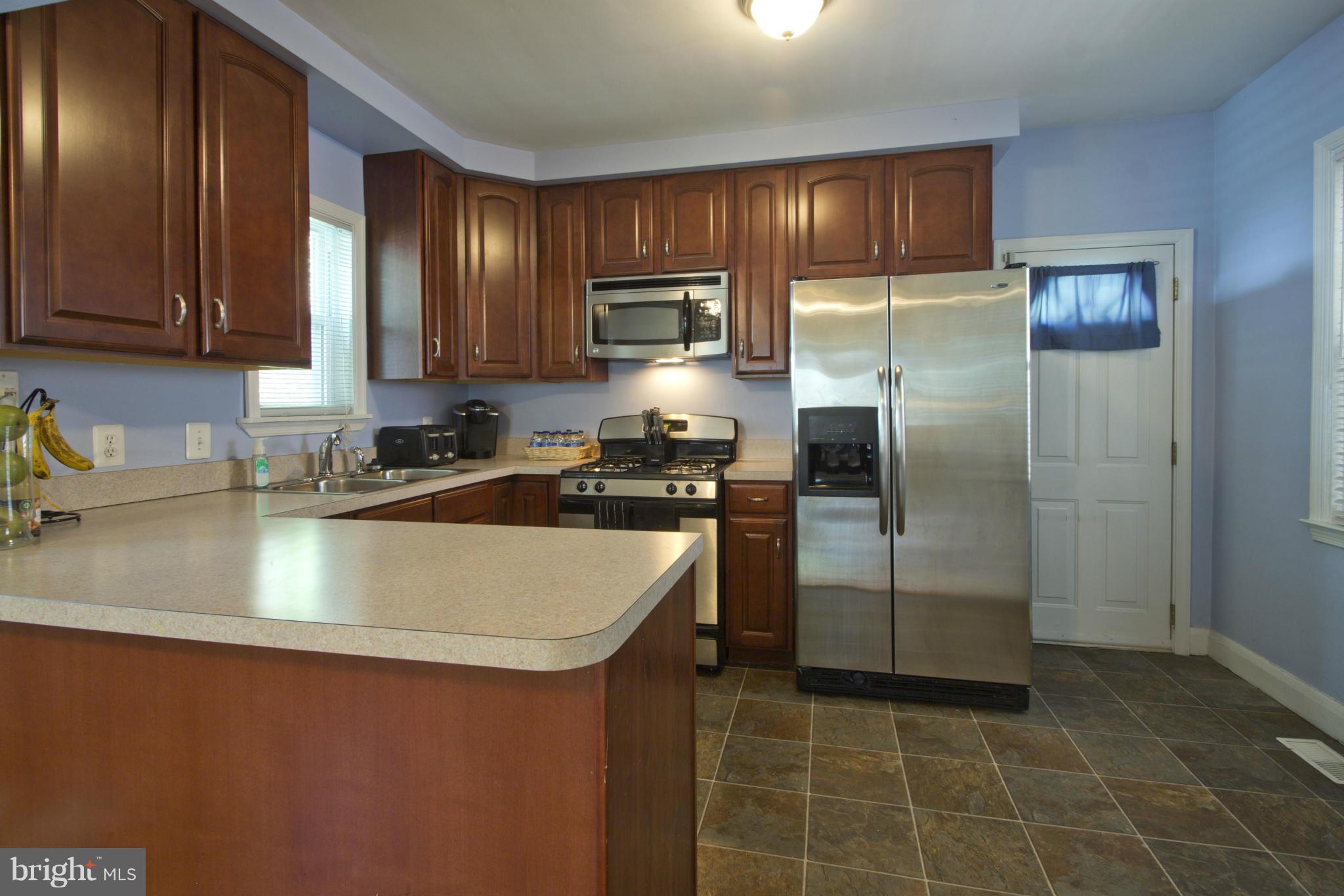 409 South Wickham Road Baltimore, MD 21229 - Photo 8 of 30 Cherry and Stainless Steel Kitchen