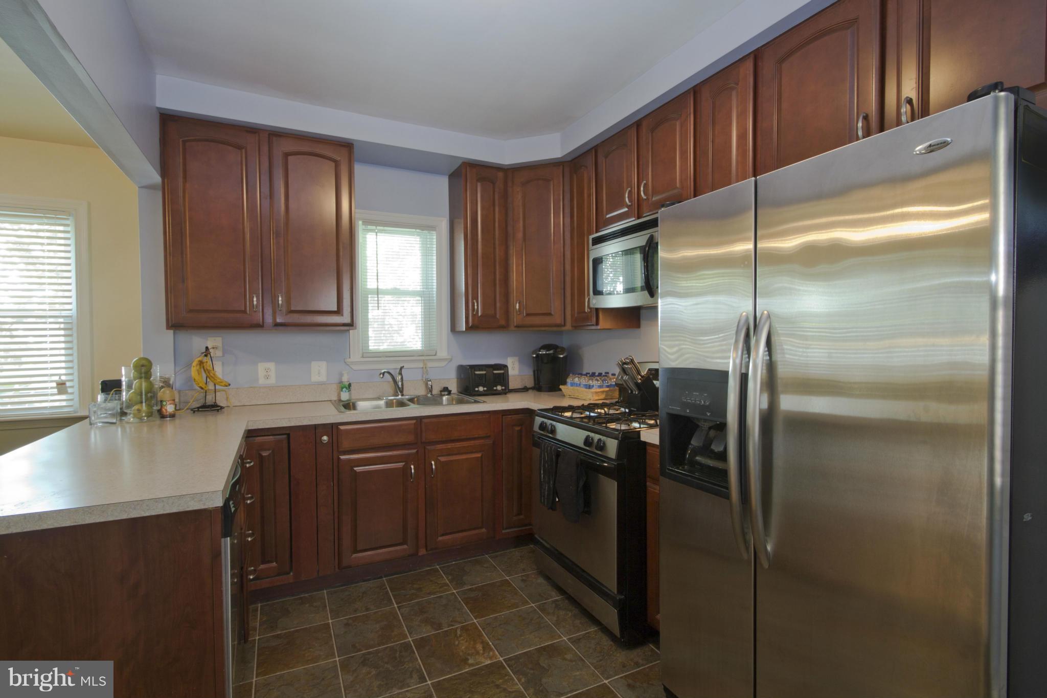 409 South Wickham Road Baltimore, MD 21229 - Photo 9 of 30 Cherry and Stainless Steel Kitchen