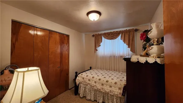 a bed sitting in a bedroom next to a window