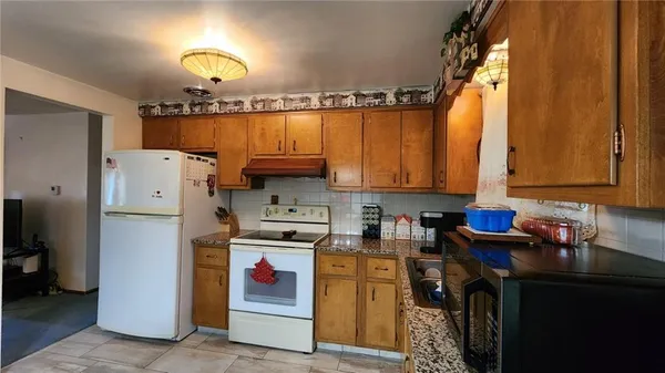 a dining room with furniture a chandelier and window