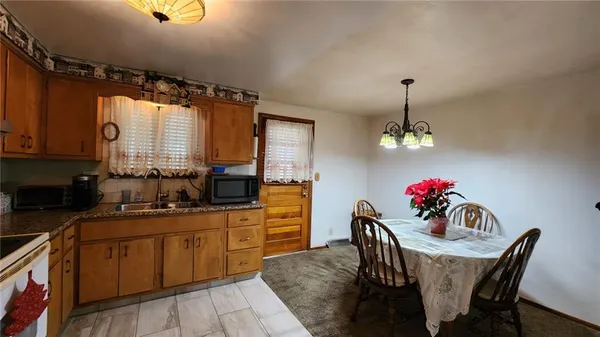 a dining room with furniture a chandelier and window