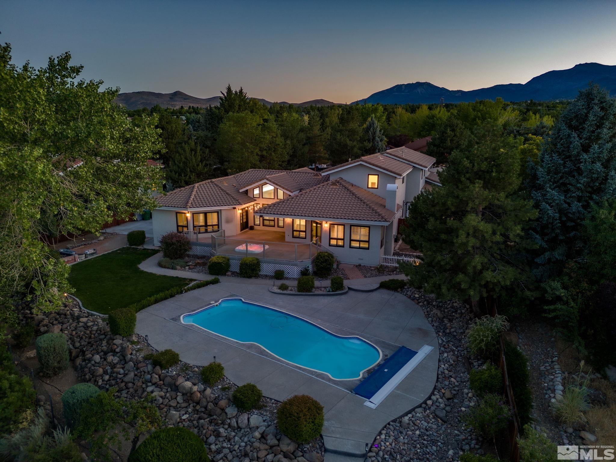 12595 Water Lily Way Reno, NV 89511 - Photo 2 of 36 an aerial view of a house with pool fire pit and outdoor seating