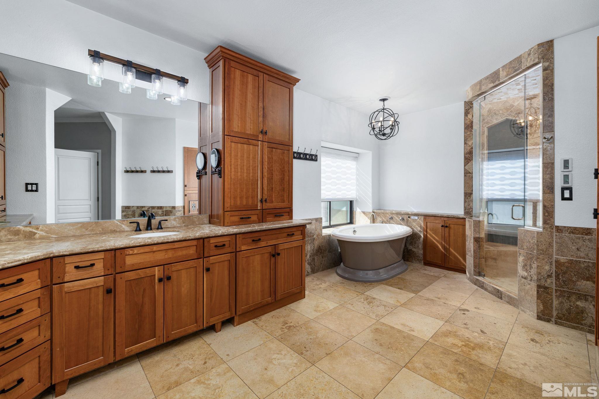 12595 Water Lily Way Reno, NV 89511 - Photo 21 of 36 a large spacious bathroom with a granite countertop toilet sink and mirror