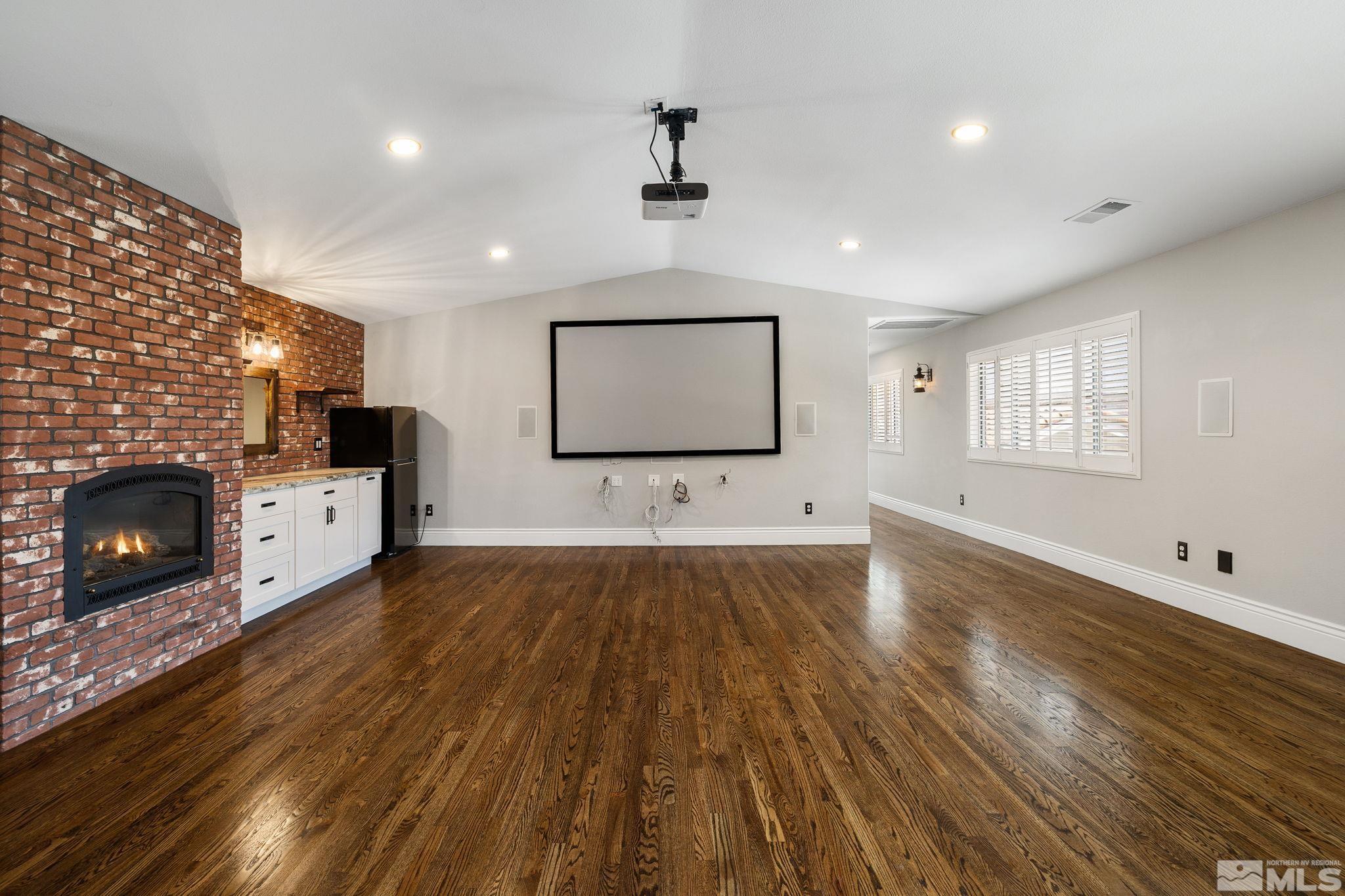 12595 Water Lily Way Reno, NV 89511 - Photo 27 of 36 a living room with hard wood floors and a fireplace