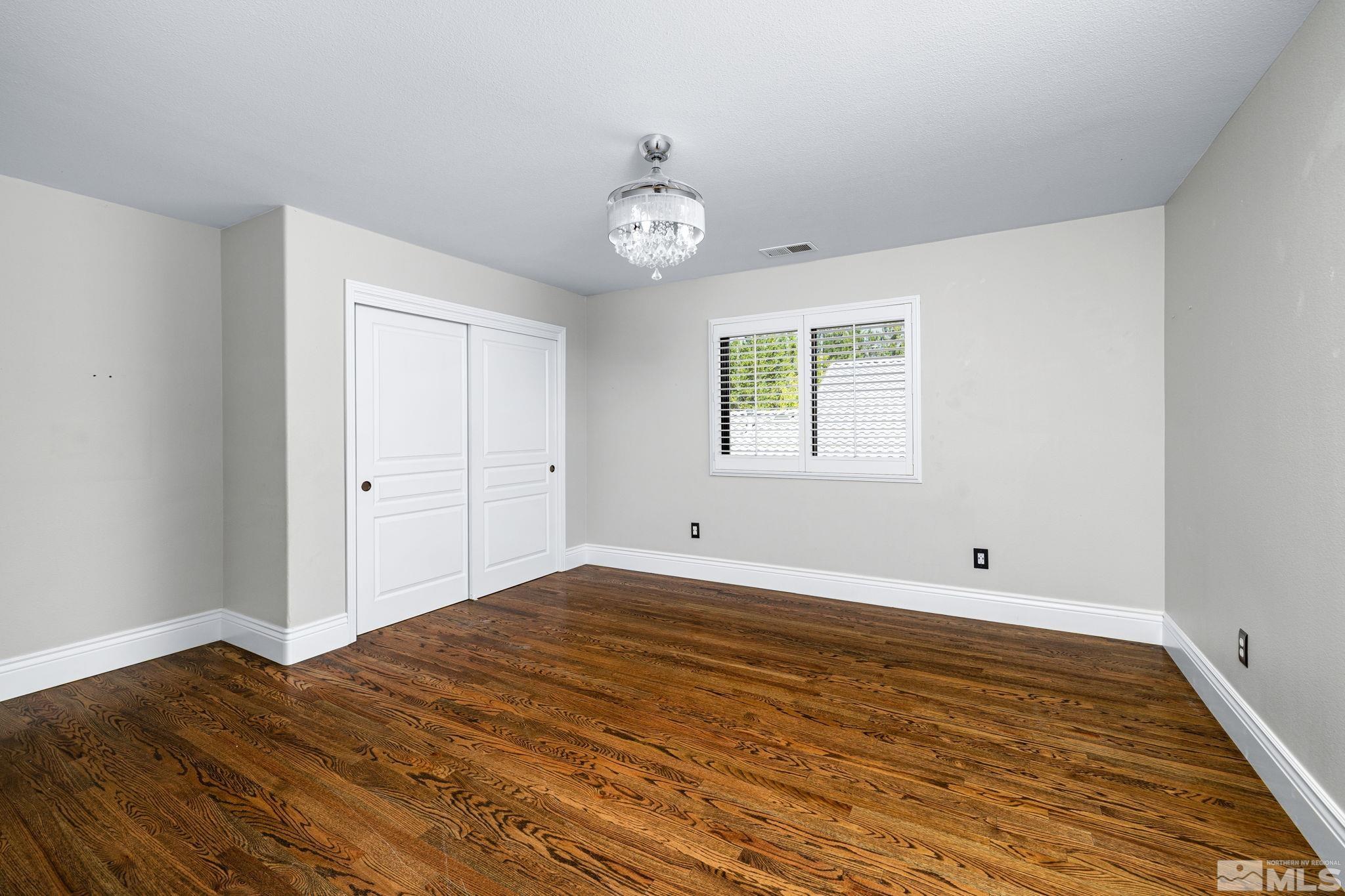 12595 Water Lily Way Reno, NV 89511 - Photo 28 of 36 wooden floor in an empty room with a window