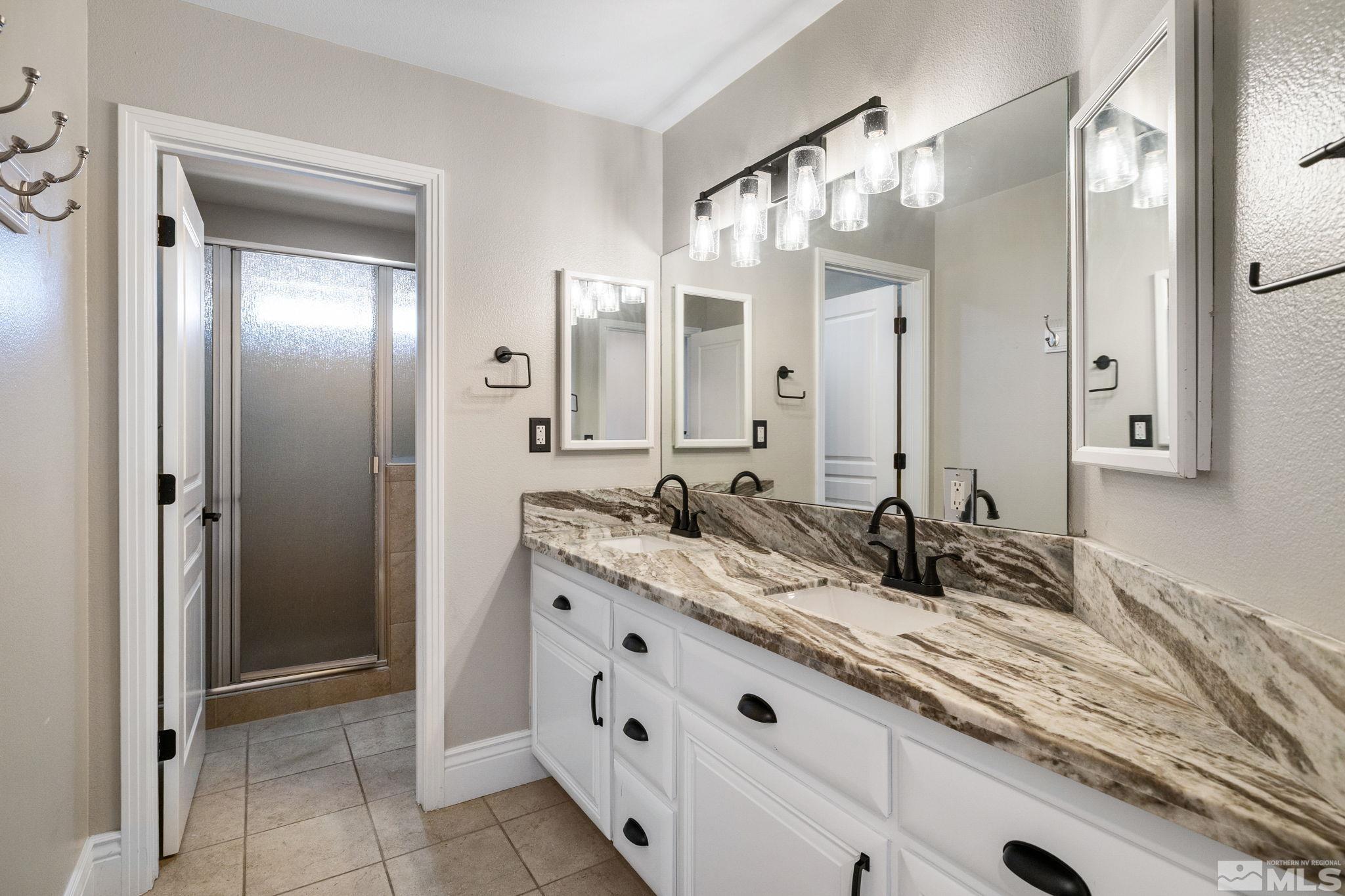 12595 Water Lily Way Reno, NV 89511 - Photo 30 of 36 a bathroom with a double vanity sink and mirror