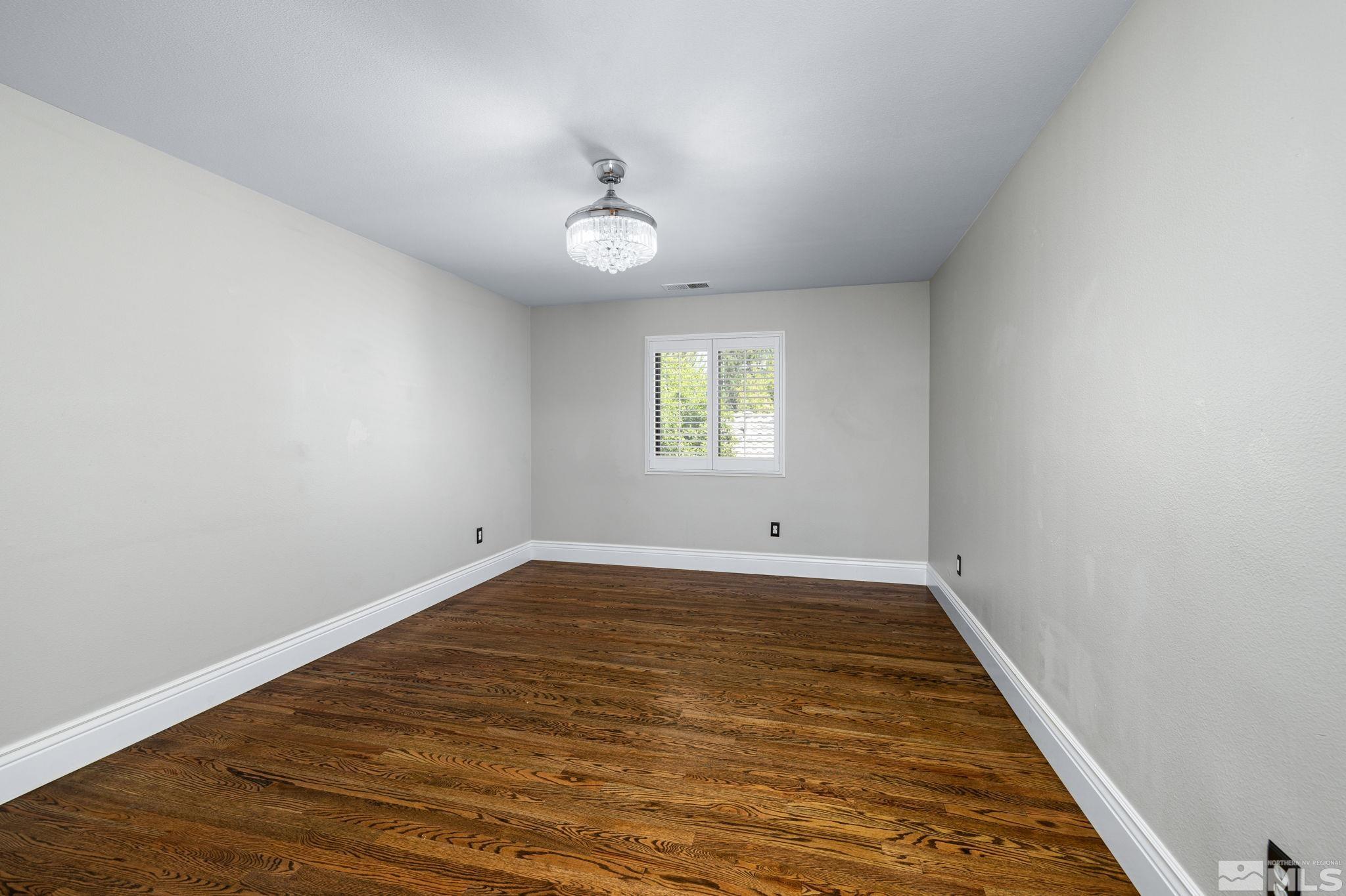 12595 Water Lily Way Reno, NV 89511 - Photo 31 of 36 an empty room with wooden floor and windows