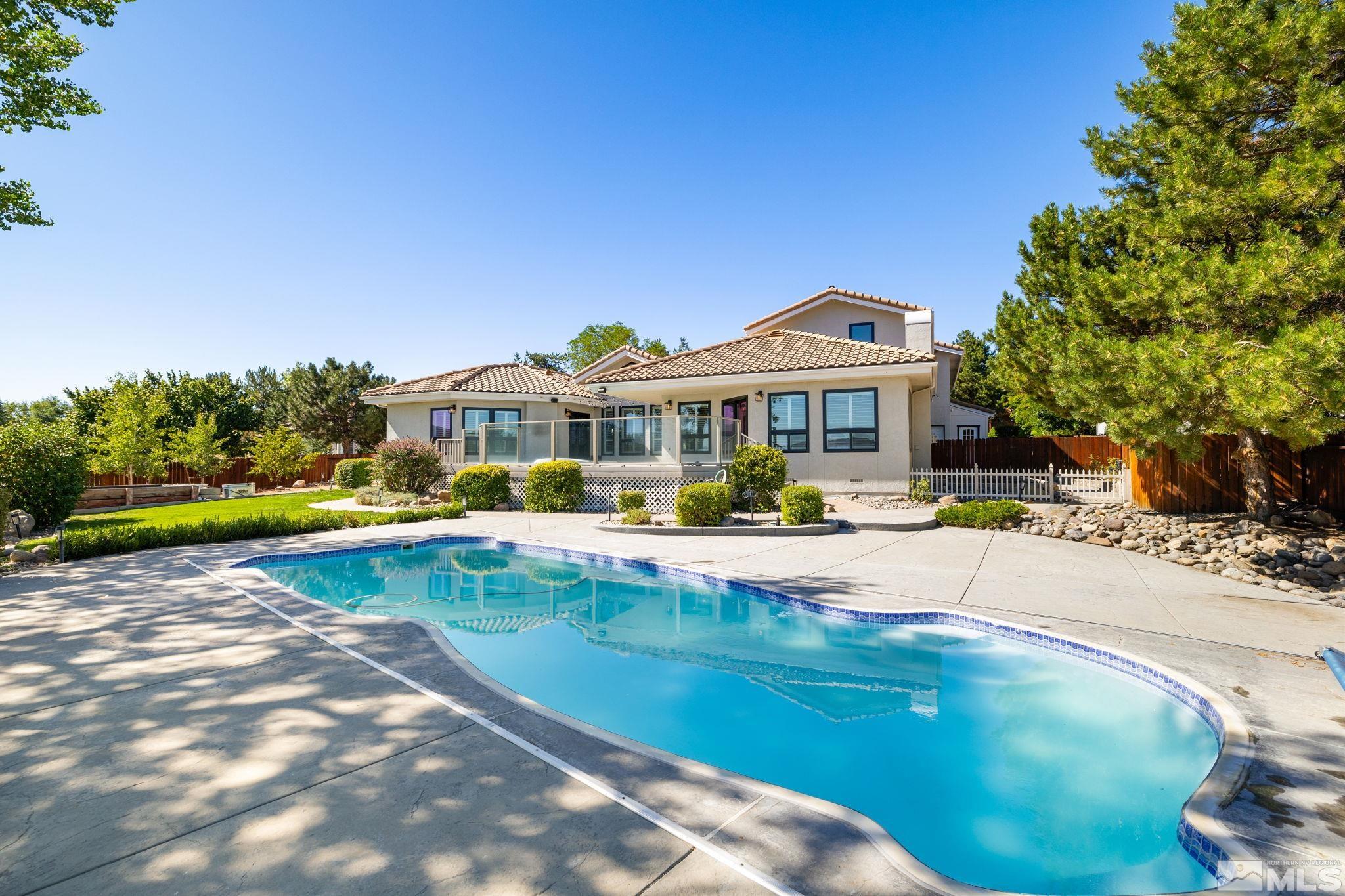 12595 Water Lily Way Reno, NV 89511 - Photo 36 of 36 a view of a house with swimming pool and sitting area
