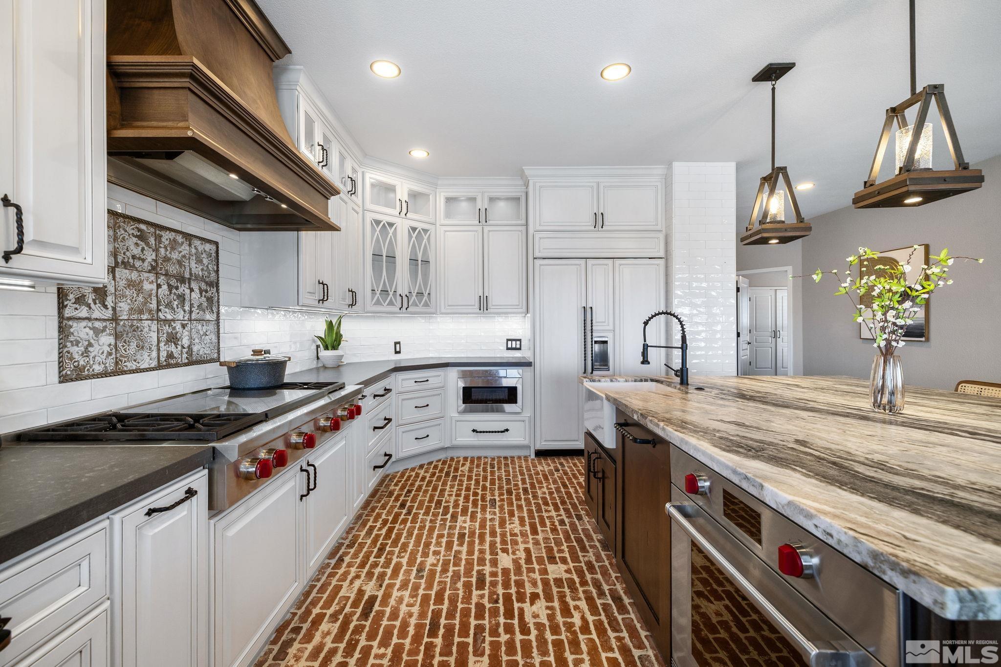 12595 Water Lily Way Reno, NV 89511 - Photo 10 of 36 a kitchen with stainless steel appliances granite countertop a sink stove and cabinets