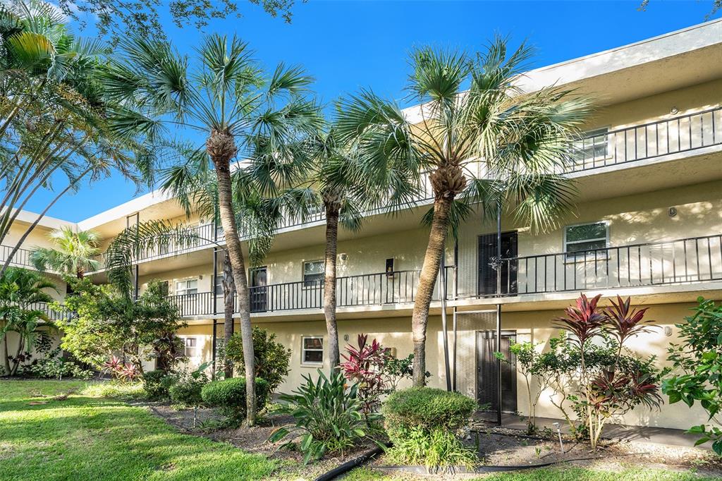 11485 Oakhurst Road, Unit 303 Largo, FL 33774 - Photo 1 of 1 a front view of a house with a garden
