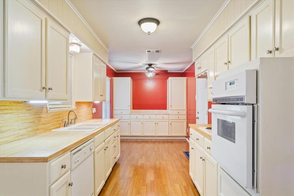 6209 May Drive Waco, TX 76710 - Photo 15 of 30 Kitchen featuring ornamental molding, light wood-type flooring, white appliances, tasteful backsplash, and ceiling fan