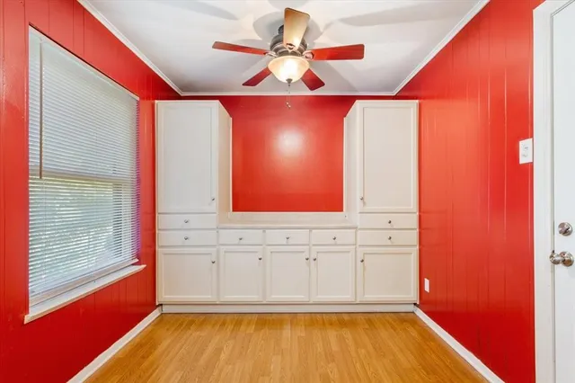 a view of a room with wooden floor and windows