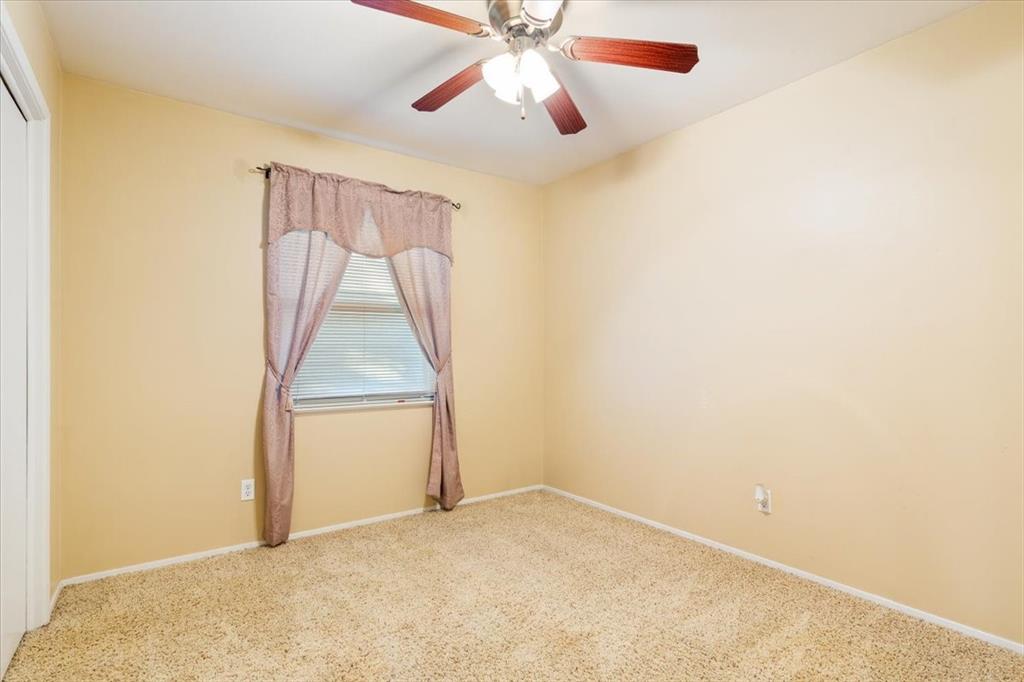 6209 May Drive Waco, TX 76710 - Photo 21 of 30 Carpeted spare room featuring baseboards and a ceiling fan