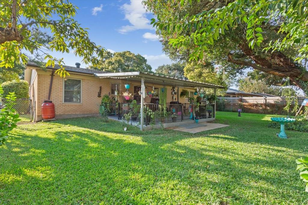 6209 May Drive Waco, TX 76710 - Photo 26 of 30 Rear view of house featuring a fenced backyard, brick siding, and a patio area