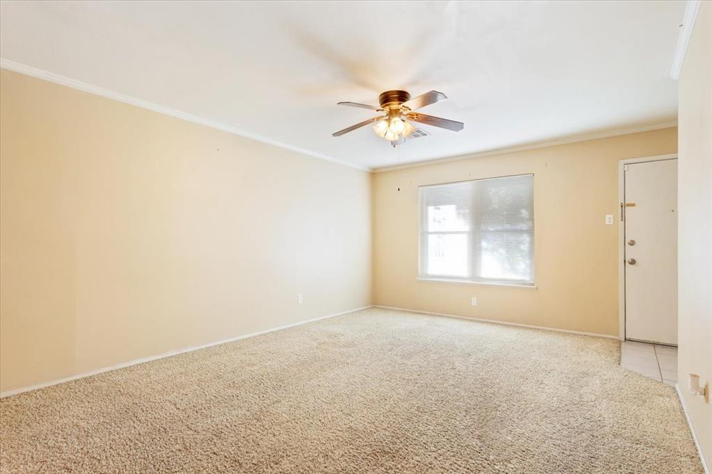 6209 May Drive Waco, TX 76710 - Photo 6 of 30 Empty room featuring crown molding, carpet, and ceiling fan