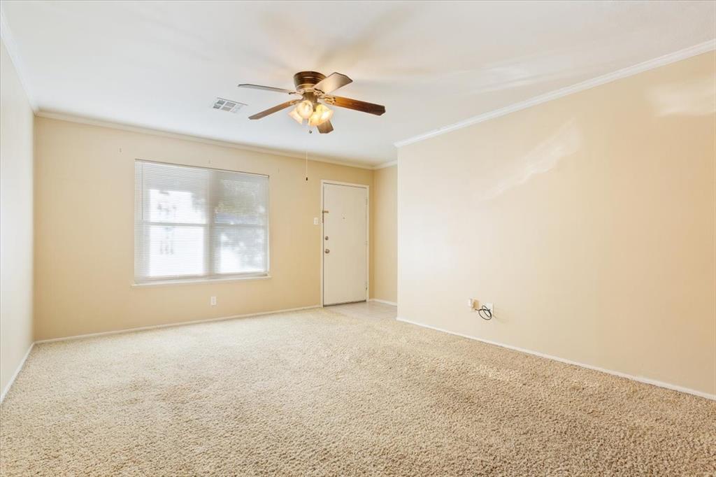 6209 May Drive Waco, TX 76710 - Photo 7 of 30 Carpeted empty room featuring ornamental molding and ceiling fan