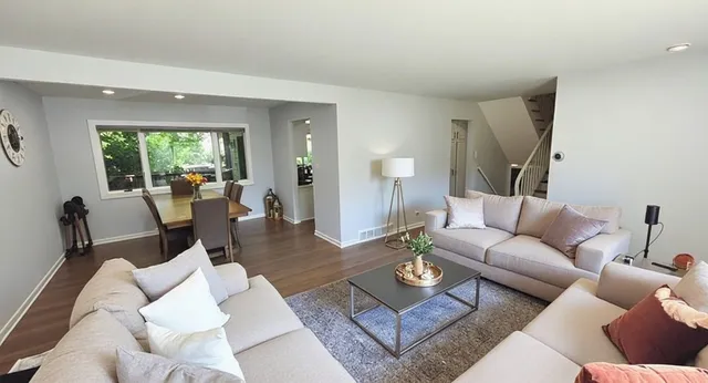 a living room with furniture and a large window