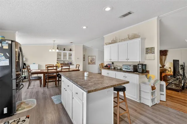 a kitchen with counter space dining table and stainless steel appliances
