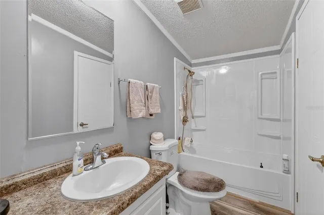 a bathroom with a sink toilet tub and shower