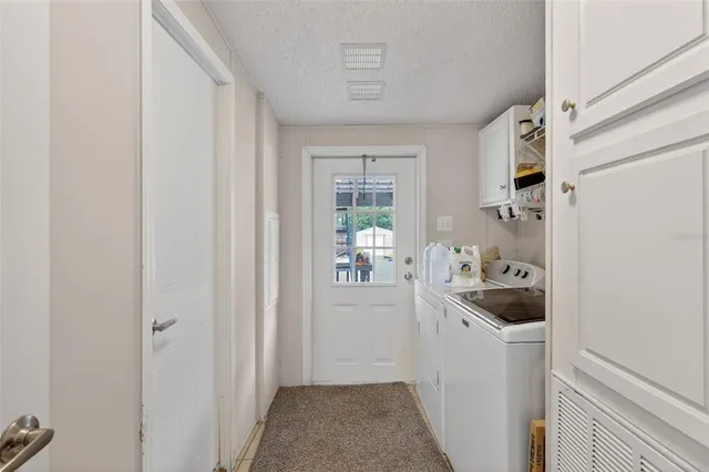 a kitchen with a refrigerator and cabinets