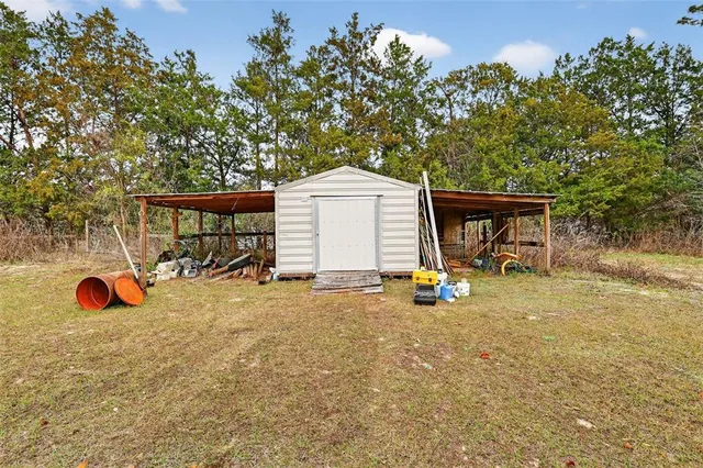 a backyard of a house with table and chairs