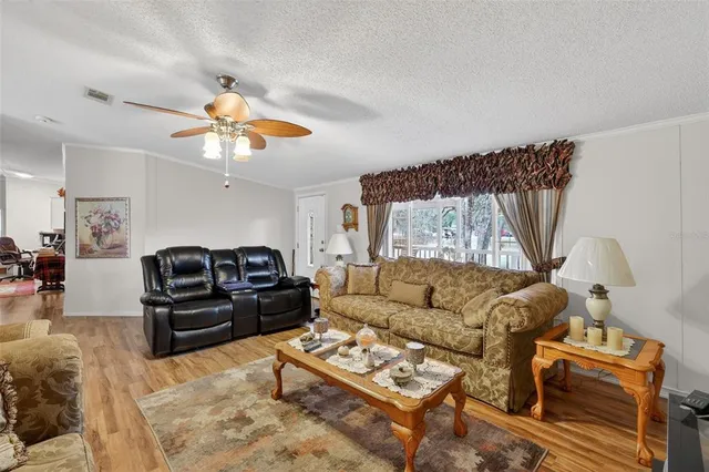 a living room with furniture a couch and wooden floor