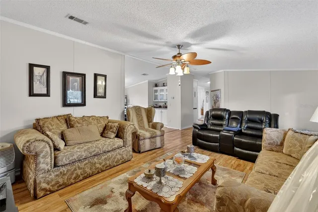 a living room with furniture a couch and chandelier
