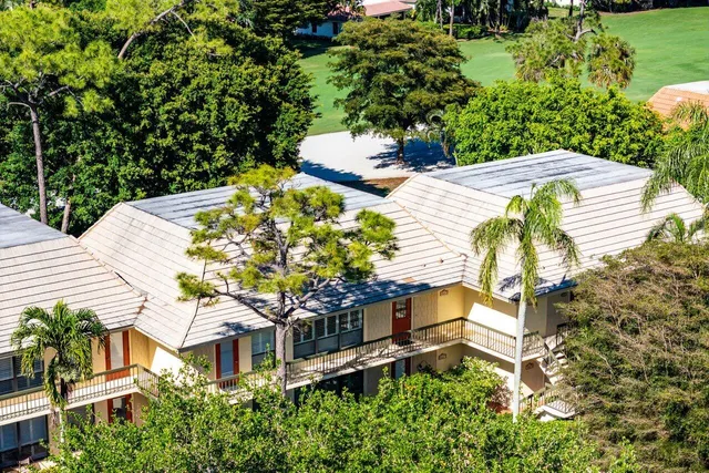 a view of a house with a yard and sitting area