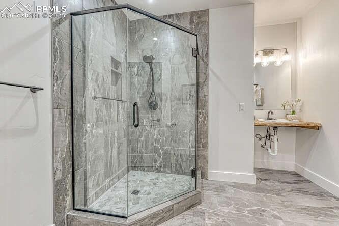 1282 South Crystal Road Lake George, CO 80827 - Photo 13 of 26 Bathroom featuring marble tiled flooring and a shower stall