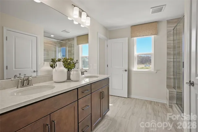 a bathroom with a sink double vanity and shower