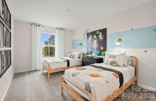 a bedroom with two beds and a window