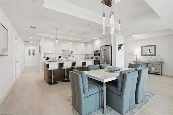 a living room with furniture wooden floor and white walls