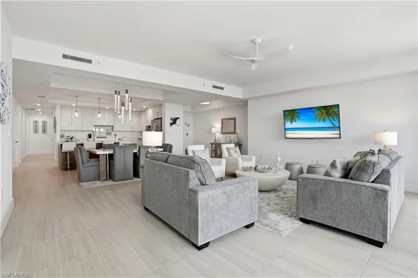 a living room with furniture kitchen area and a view of kitchen