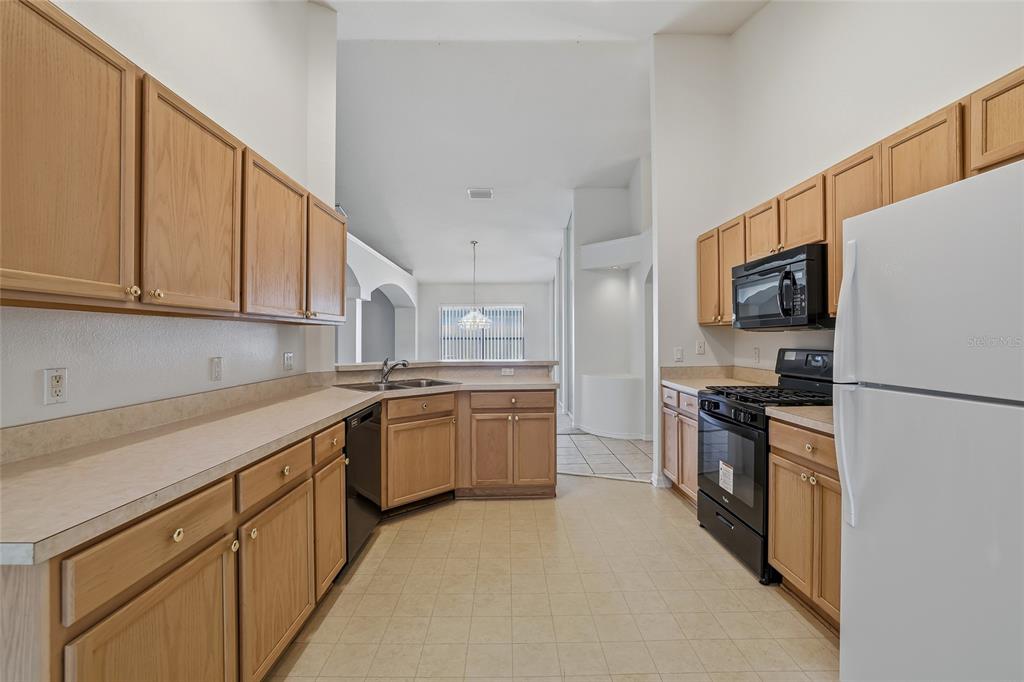 6935 Freeport Road Riverview, FL 33578 - Photo 12 of 51 a kitchen with a sink stove and refrigerator