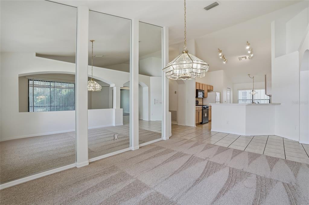6935 Freeport Road Riverview, FL 33578 - Photo 17 of 51 a view of a big room with chandelier and windows
