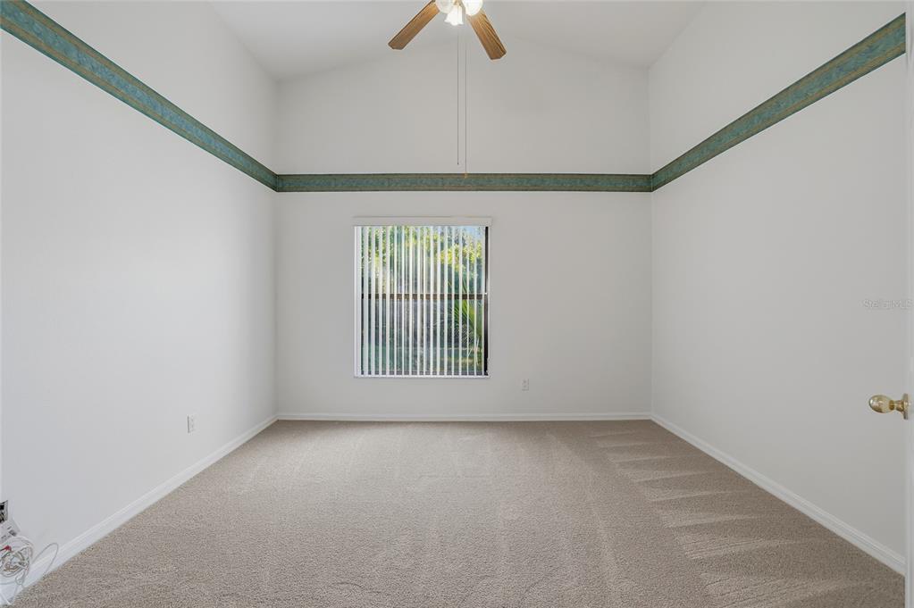 6935 Freeport Road Riverview, FL 33578 - Photo 22 of 51 an empty room with chandelier fan and windows