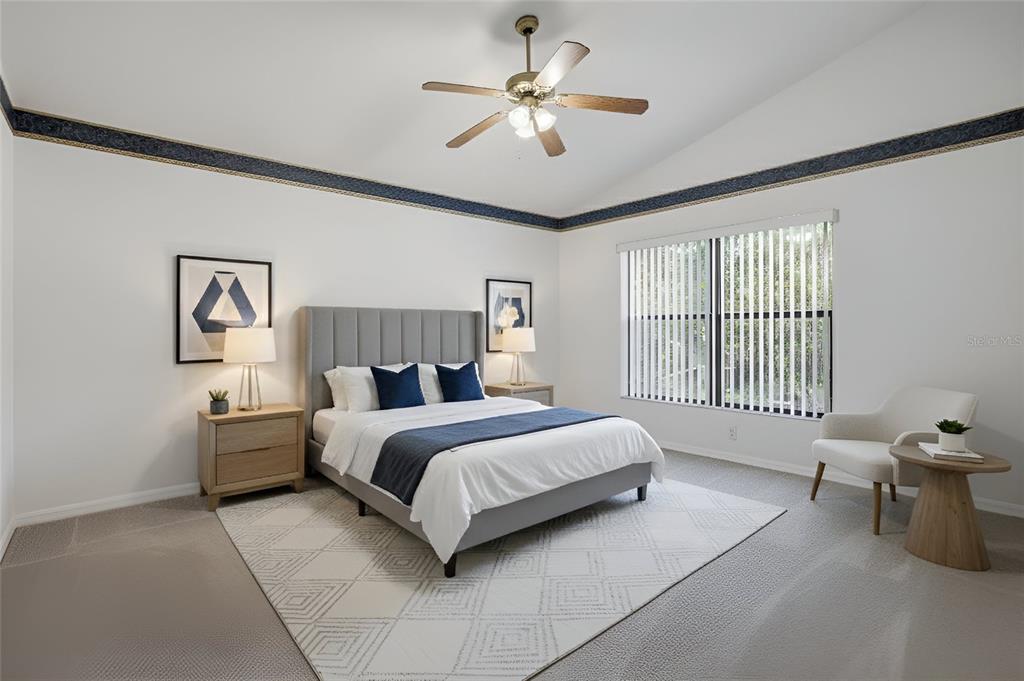 6935 Freeport Road Riverview, FL 33578 - Photo 25 of 51 a spacious bedroom with a bed and a chandelier