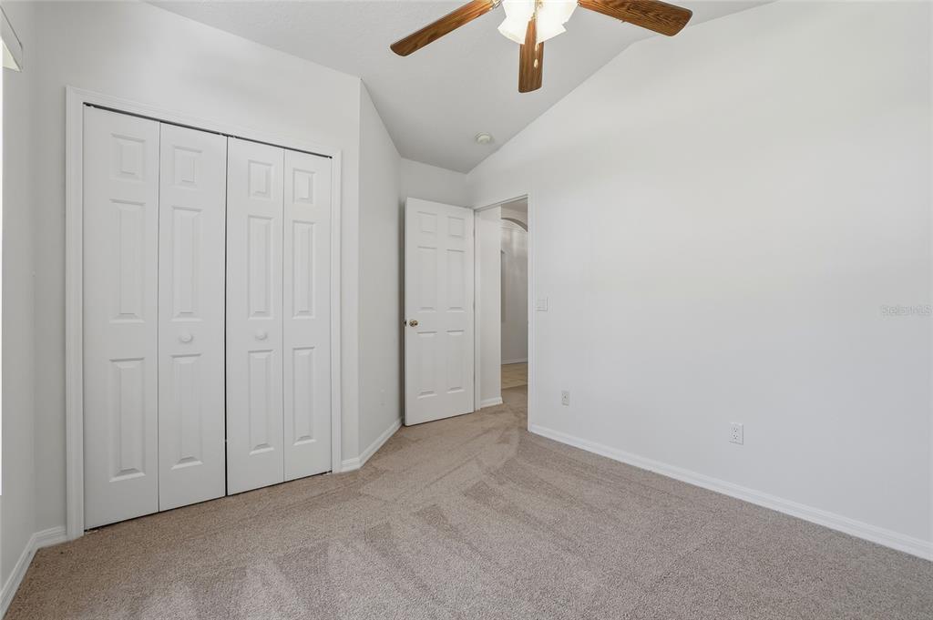6935 Freeport Road Riverview, FL 33578 - Photo 34 of 51 an empty room with a chandelier fan