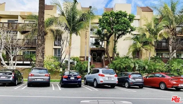 a view of a cars park in front of a building
