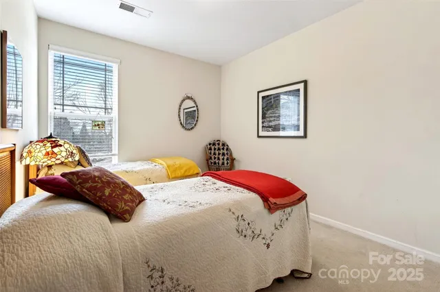 a bedroom with a bed and a lamp