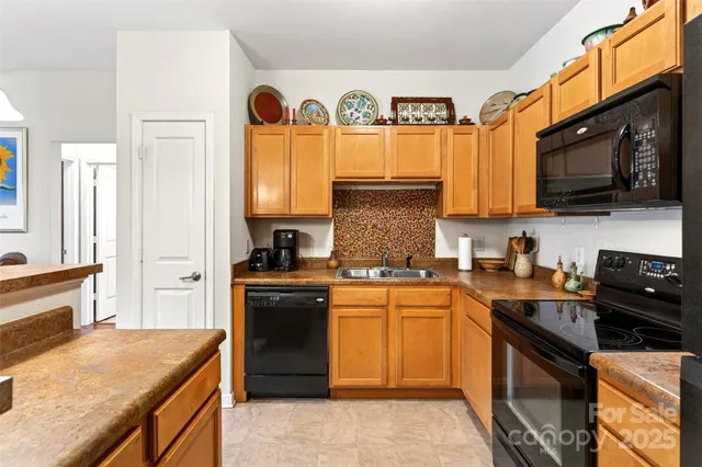 a kitchen with a stove a sink and a microwave