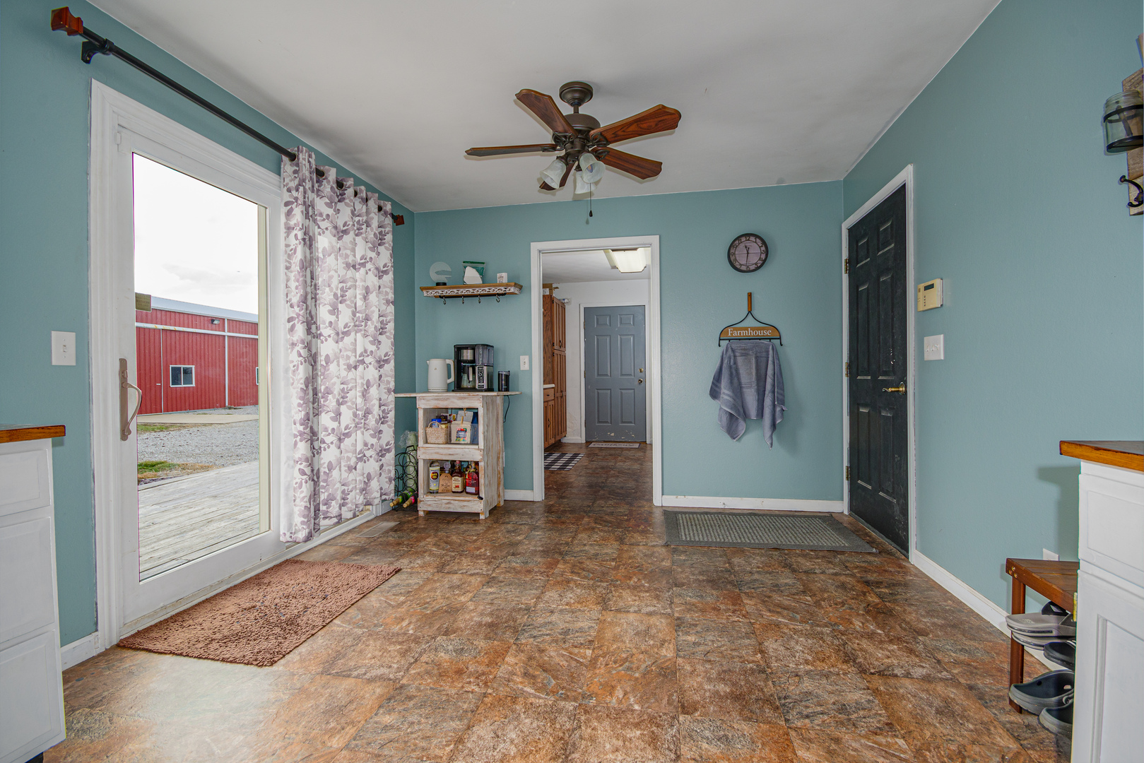 4786 Keller Road Iuka, IL 62849 - Photo 14 of 40 a view of a hallway with a livingroom with furniture and a ceiling fan