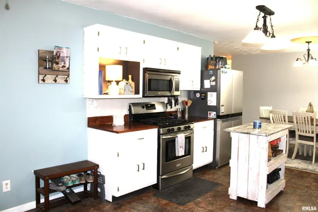 a kitchen with cabinets a sink and appliances