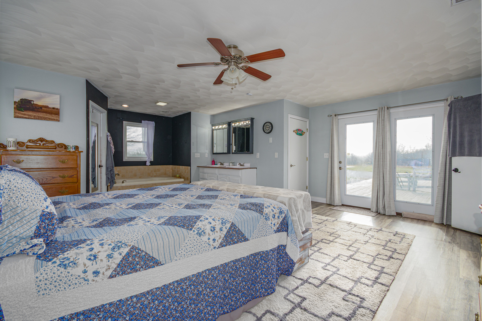 4786 Keller Road Iuka, IL 62849 - Photo 19 of 40 a spacious bedroom with a large bed a flat screen tv and a dresser
